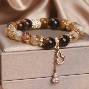 Women's beaded bracelet with crystal stones and gold-tone metal details