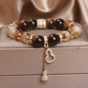 Women's beaded bracelet with crystal stones and gold-tone metal details